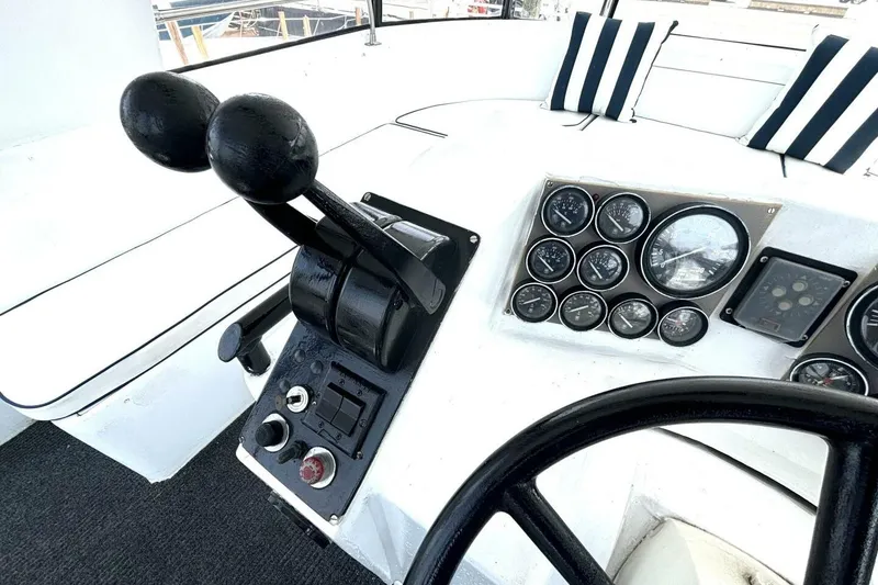 Slide: The Image of Control panel of 1987 Davidson 48 Sportfish boat with gauges and throttle levers. - 25