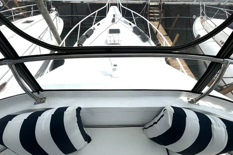 Slide: The Image of 1987 Davidson 48 Sportfish yacht interior with striped cushions and marina view. - 30