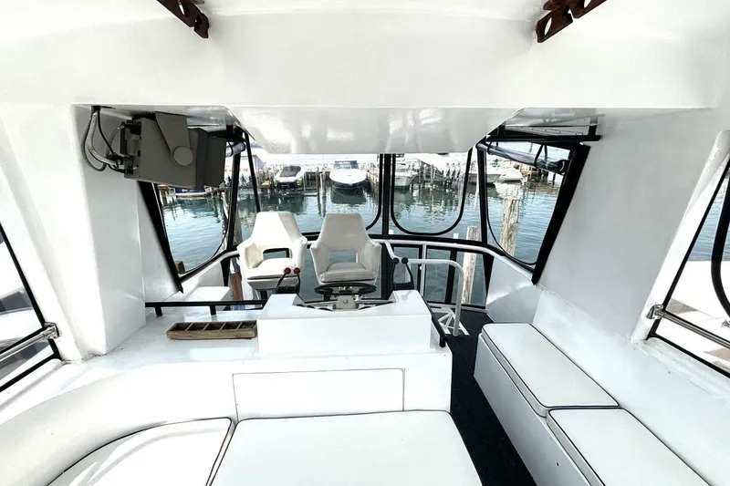 Slide: The Image of Interior of 1987 Davidson 48 Sportfish boat with seating and helm, docked at marina. - 31