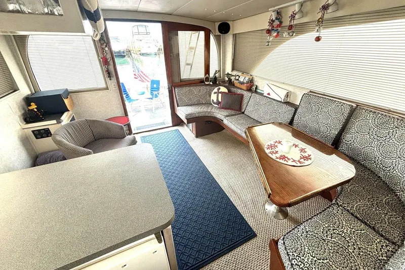 Slide: The Image of Interior of 1987 Davidson 48 Sportfish yacht with cozy seating and nautical decor. - 37
