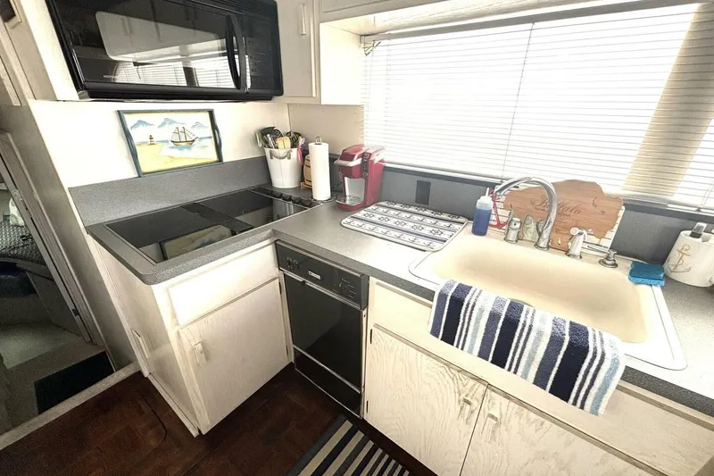 Slide: The Image of 1987 Davidson 48 Sportfish kitchen with modern appliances and nautical decor. - 39