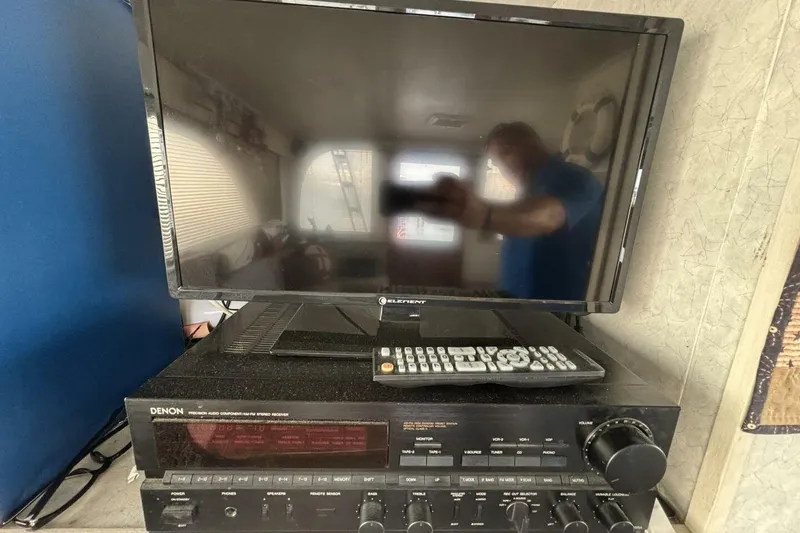 Slide: The Image of Denon stereo receiver with remote and TV on Davidson 48 Sportfish, 1987 model. - 47