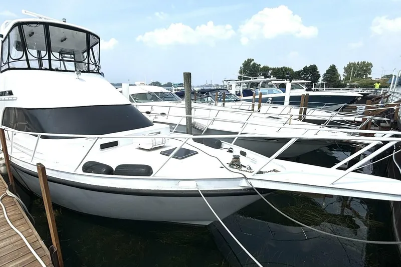 Slide: The Image of 1987 Davidson 48 Sportfish yacht docked at marina under clear sky. - 5