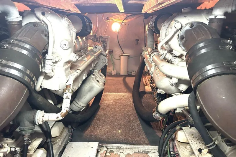 Slide: The Image of Engine room of 1987 Davidson 48 Sportfish boat, showcasing dual engines and mechanical components. - 51
