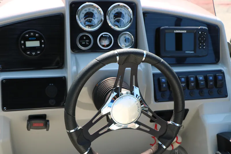 Slide: The Image of 2023 Sylvan Mirage Fish 820 Party Fish dashboard with steering wheel and control panel. - 19