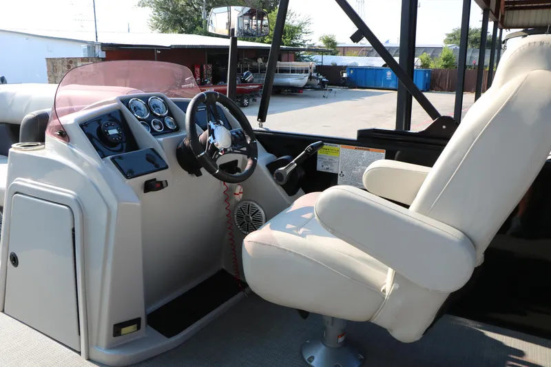 Slide: The Image of 2023 Sylvan Mirage Fish 820 Party Fish boat cockpit with steering wheel and captain's chair. - 21