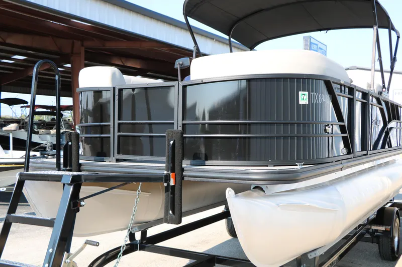 Slide: The Image of 2023 Sylvan Mirage Fish 820 Party Fish pontoon boat on trailer in storage facility. - 6