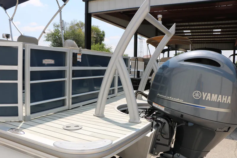 Slide: The Image of 2017 Trifecta 21 F Sts pontoon boat with Yamaha outboard motor in a covered dock. - 11