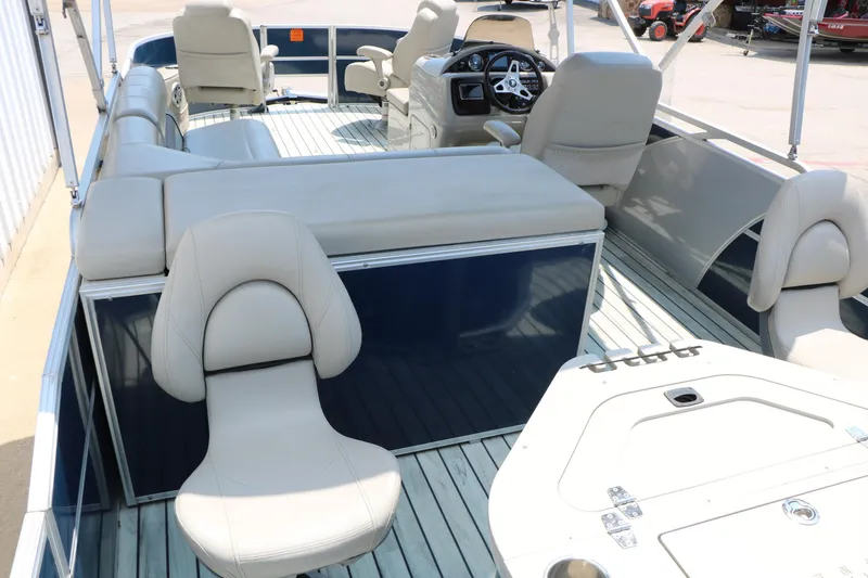 Slide: The Image of 2017 Trifecta 21 F Sts pontoon boat interior with beige seating and steering console. - 22