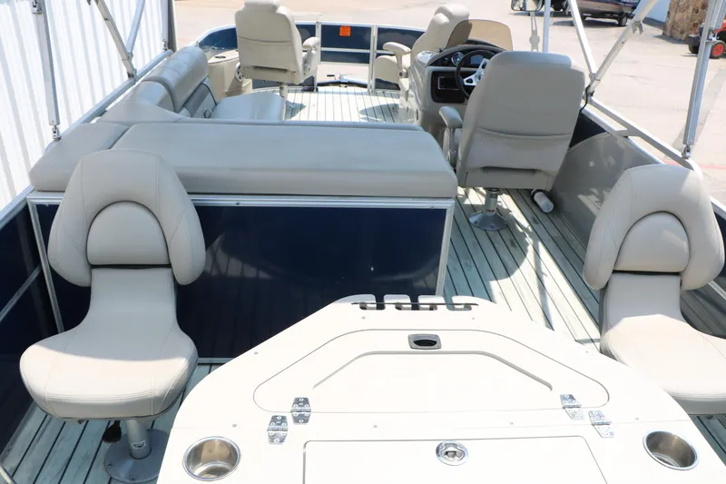 Slide: The Image of 2017 Trifecta 21 F Sts pontoon boat interior with beige seating and steering console. - 24