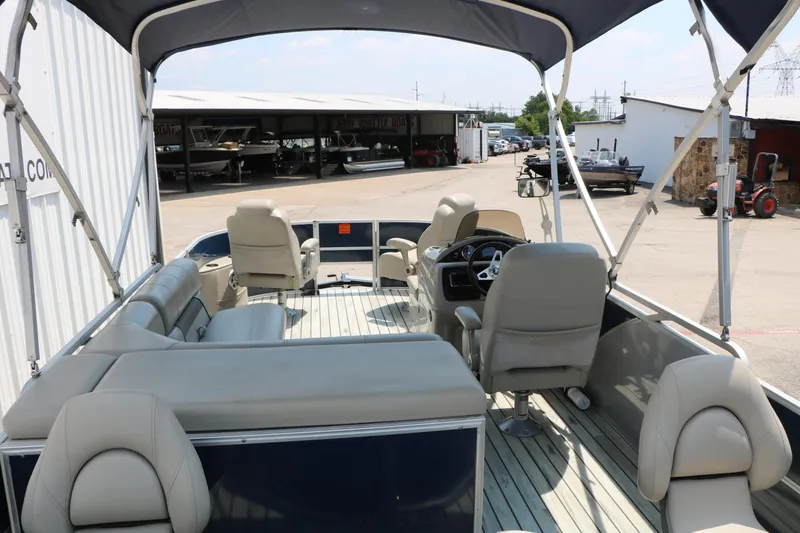 Slide: The Image of 2017 Trifecta 21 F Sts pontoon boat with spacious seating and canopy in a marina. - 25