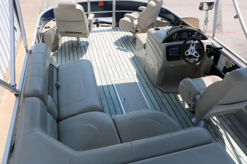 Slide: The Image of 2017 Trifecta 21 F Sts pontoon boat interior with gray seating and steering console. - 27