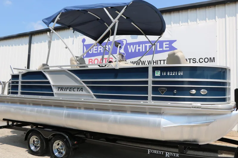 Slide: The Image of 2017 Trifecta 21 F Sts pontoon boat with blue canopy on trailer. - 3