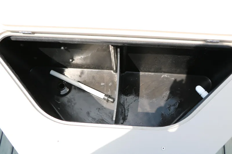 Slide: The Image of Open storage compartment in 2017 Trifecta 21 F Sts boat, featuring black interior. - 30