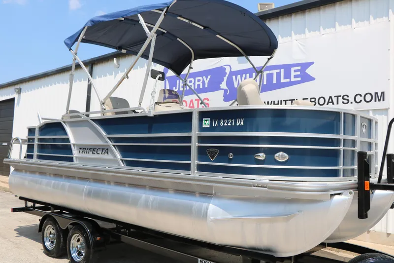 Slide: The Image of 2017 Trifecta 21 F Sts pontoon boat with blue canopy on trailer. - 4