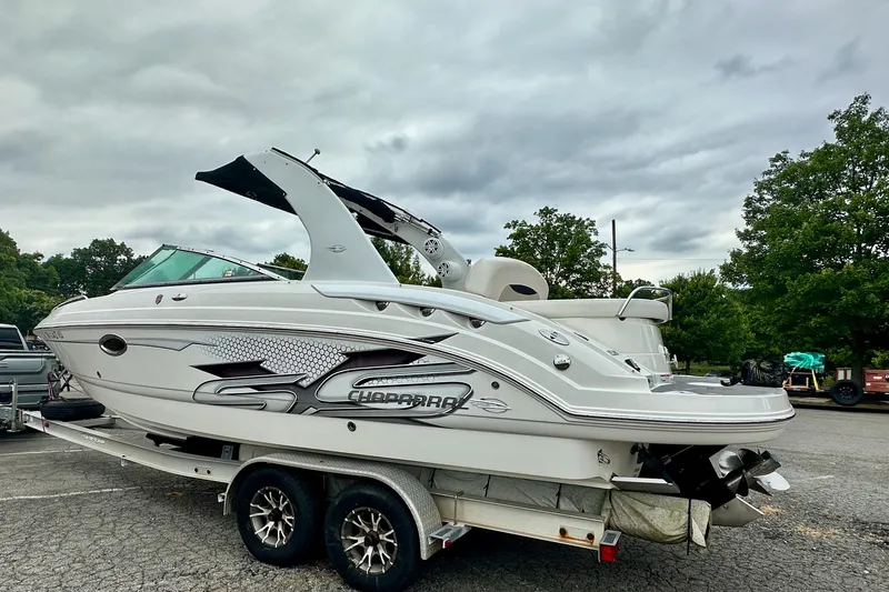 The Image of 2011 Chaparral 267 SSX boat on trailer, parked outdoors with overcast sky. - 0