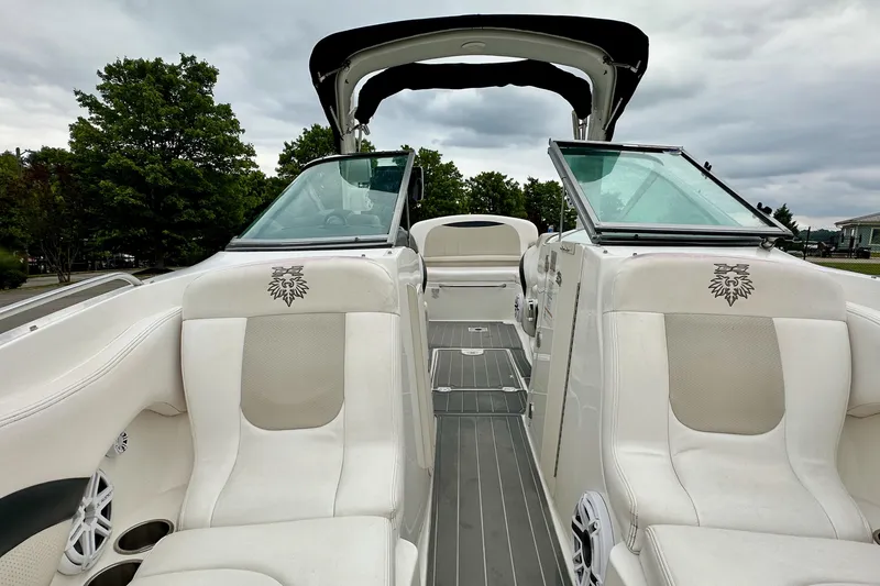 Slide: The Image of 2011 Chaparral 267 SSX boat interior with white seating and open windshield. - 12