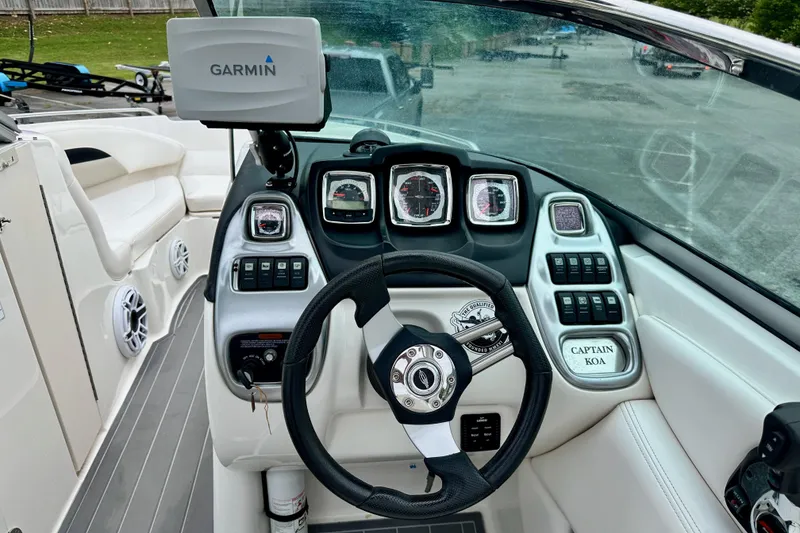 Slide: The Image of Cockpit of 2011 Chaparral 267 SSX boat with Garmin navigation system and steering wheel. - 4