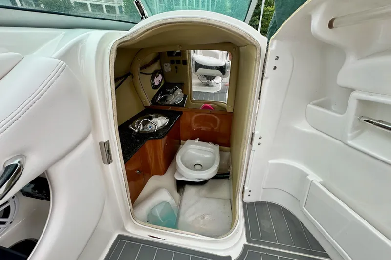 Slide: The Image of 2011 Chaparral 267 SSX boat interior with compact bathroom and sink. - 9