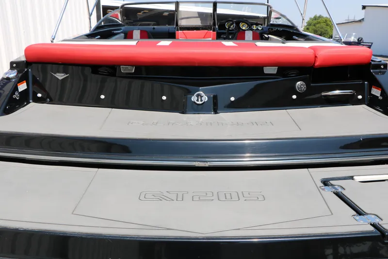 Slide: The Image of 2015 Glastron 205 GTS boat with red seating and sleek black exterior. - 11