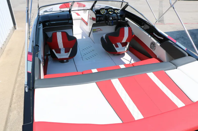 Slide: The Image of 2015 Glastron 205 GTS boat interior with red and white seating, steering wheel, and dashboard. - 15