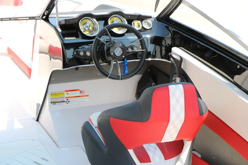 Slide: The Image of Interior of 2015 Glastron 205 GTS boat with steering wheel and red seat. - 17