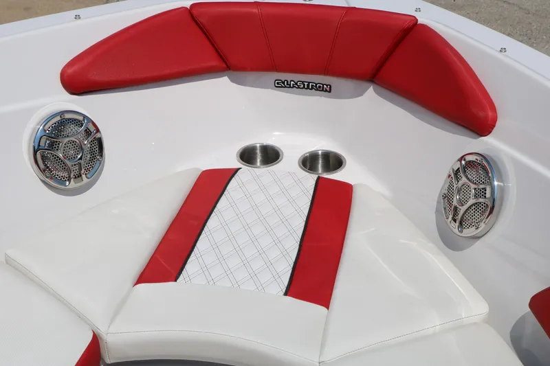 Slide: The Image of 2015 Glastron 205 GTS boat interior with red and white seating, speakers, and cup holders. - 20
