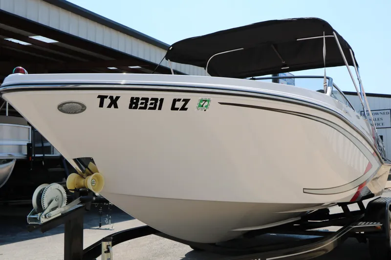 Slide: The Image of 2015 Glastron 205 GTS boat on trailer, white hull, black canopy, side view. - 8