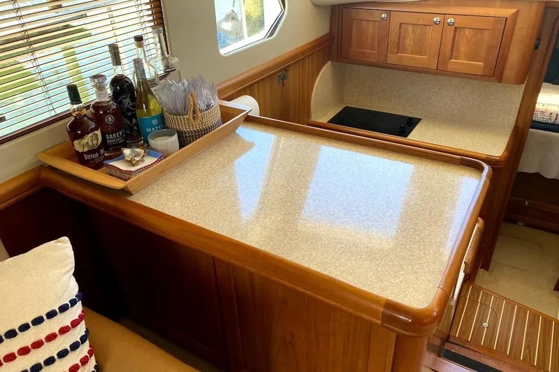 Slide: The Image of Interior of 2005 Mainship 34 Trawler with wooden cabinetry and countertop. - 12