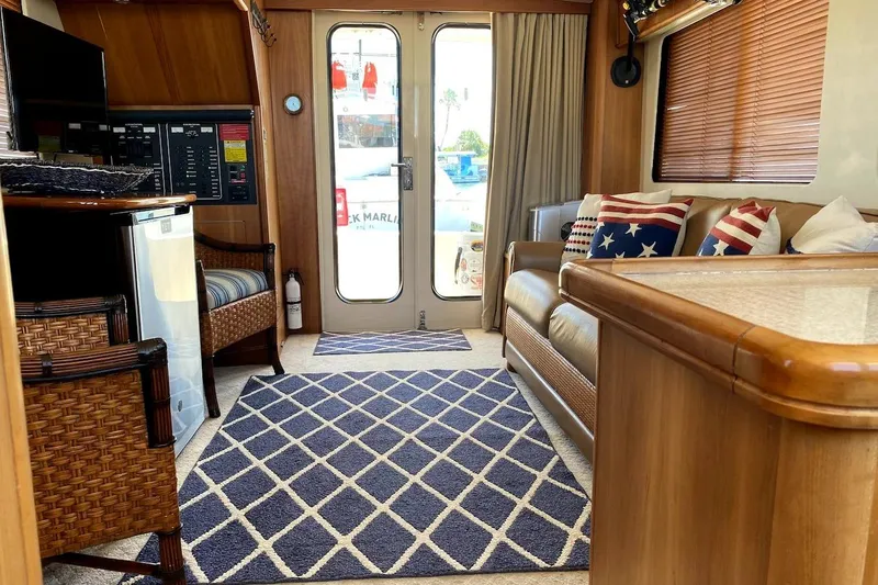 Slide: The Image of Interior of 2005 Mainship 34 Trawler with cozy seating and nautical decor. - 14