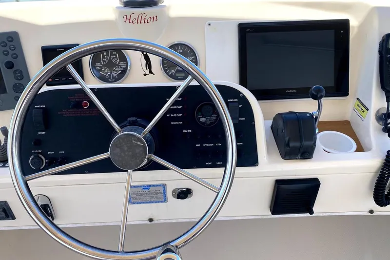 Slide: The Image of Helm of 2005 Mainship 34 Trawler with steering wheel, gauges, and navigation equipment. - 27