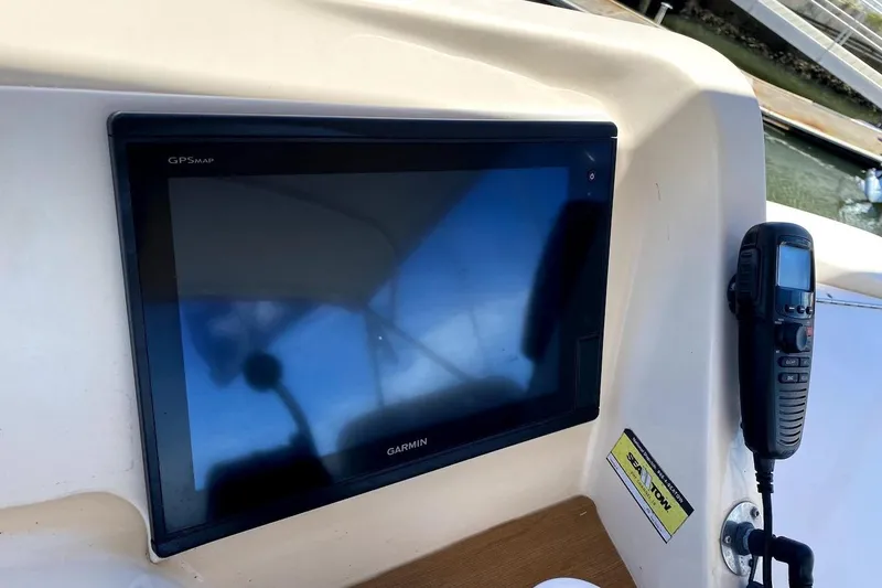 Slide: The Image of Garmin GPS and radio on 2005 Mainship 34 Trawler dashboard. - 29