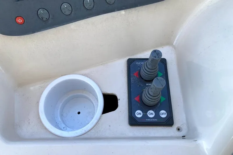 Slide: The Image of Control panel of a 2005 Mainship 34 Trawler with joystick thrusters and cup holder. - 30