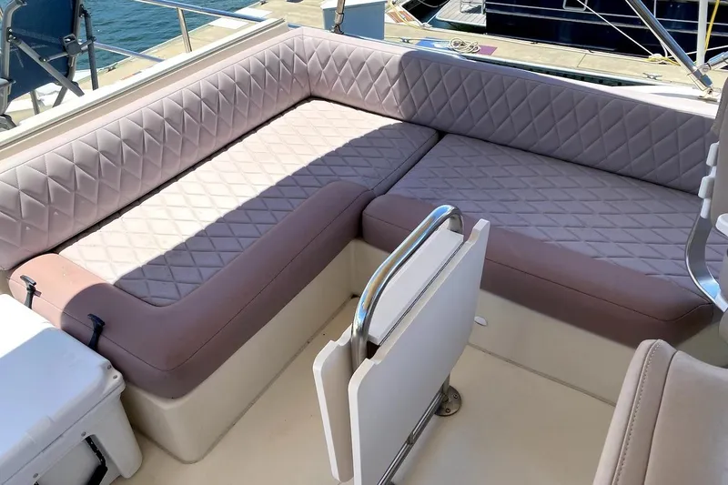 Slide: The Image of 2005 Mainship 34 Trawler interior with cushioned seating and nautical design. - 32
