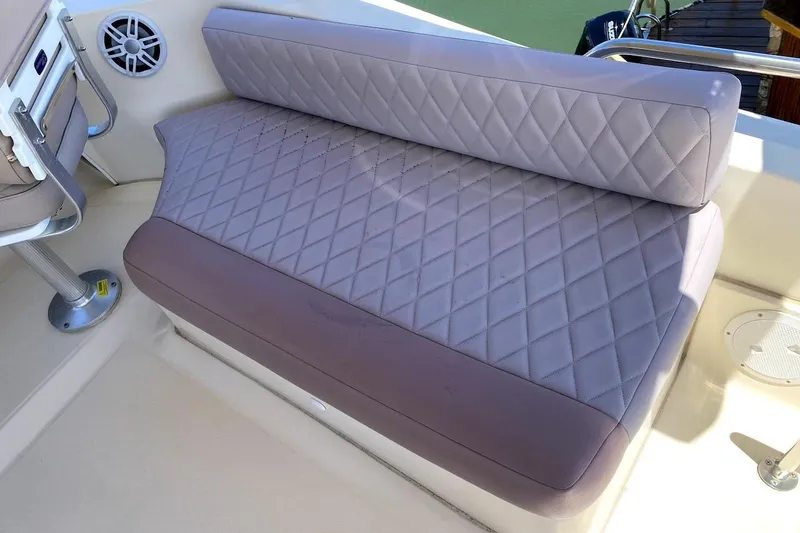 Slide: The Image of 2005 Mainship 34 Trawler interior with quilted seating and speaker detail. - 35