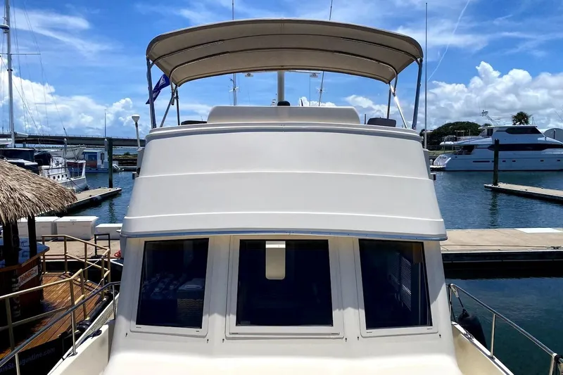 Slide: The Image of 2005 Mainship 34 Trawler docked at marina under clear blue sky. - 40