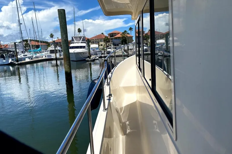 Slide: The Image of 2005 Mainship 34 Trawler docked at marina, sunny day, clear reflections on water. - 42