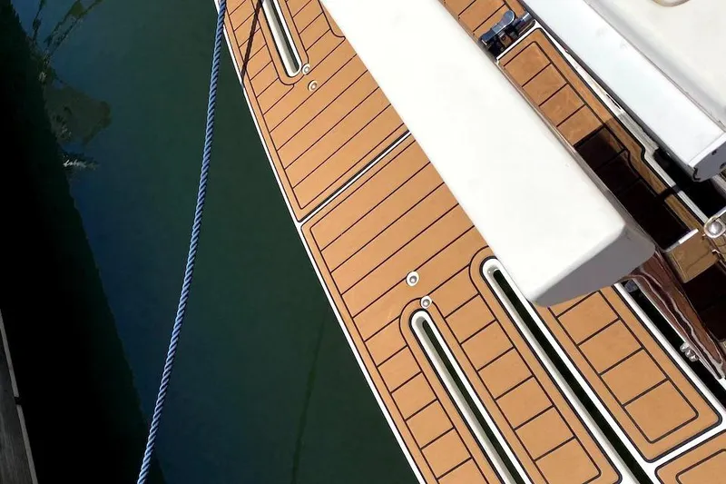 Slide: The Image of Deck of 2005 Mainship 34 Trawler with teak flooring and mooring rope. - 43
