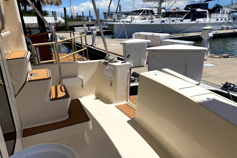 Slide: The Image of 2005 Mainship 34 Trawler docked, showcasing deck and marina view. - 44