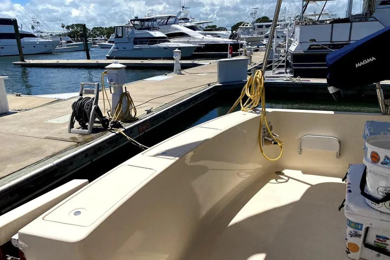 Slide: The Image of 2005 Mainship 34 Trawler docked at marina, surrounded by other boats. - 45