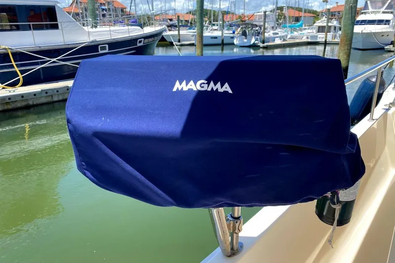 Slide: The Image of Blue Magma grill cover on 2005 Mainship 34 Trawler, docked in a marina. - 46