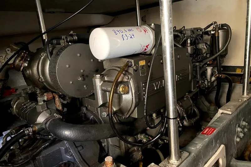 Slide: The Image of Engine compartment of a 2005 Mainship 34 Trawler, showcasing mechanical components. - 49