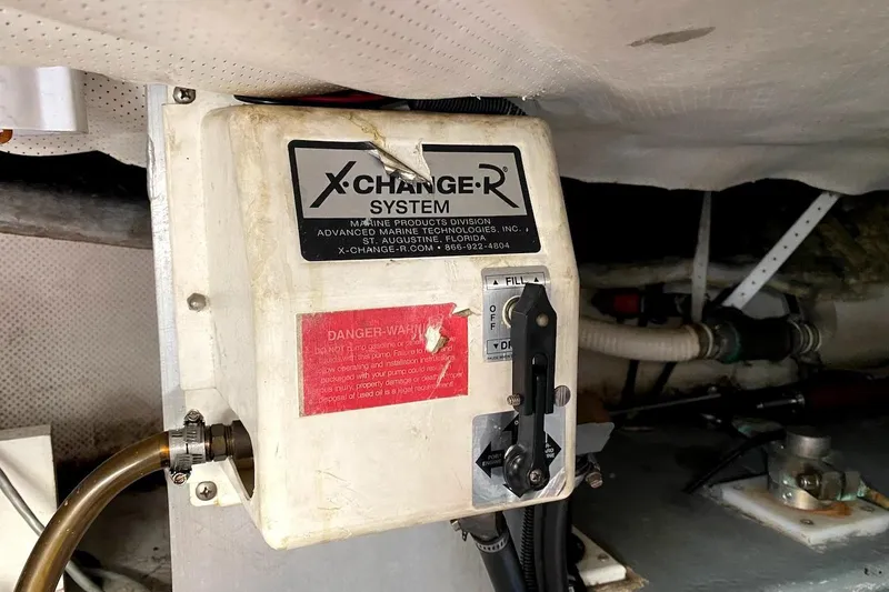 Slide: The Image of X-Change-R system in 2005 Mainship 34 Trawler engine room, showing control panel and hoses. - 52