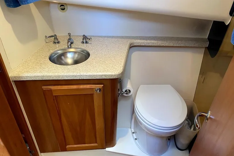 Slide: The Image of 2005 Mainship 34 Trawler bathroom with sink, countertop, and toilet. - 6