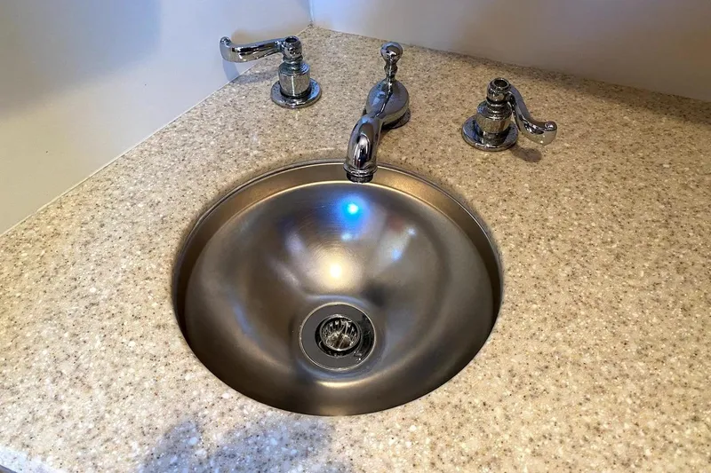 Slide: The Image of Stainless steel sink with chrome fixtures on a Mainship 34 Trawler, 2005 model. - 8