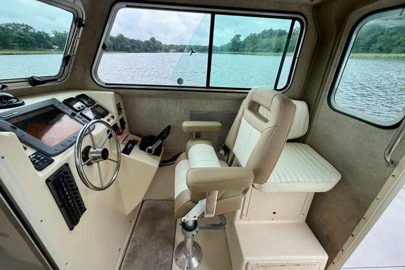 Slide: The Image of Interior of 2008 Parker 2520XLD boat with steering wheel and captain's chair. - 11