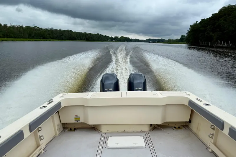 Slide: The Image of 2008 Parker 2520XLD boat cruising on a river under cloudy skies. - 15