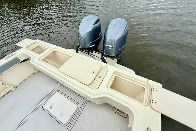 Slide: The Image of 2008 Parker 2520XLD boat with twin 200 horsepower outboard engines on water. - 4