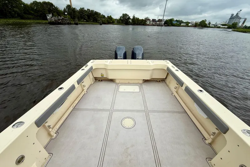 Slide: The Image of 2008 Parker 2520XLD boat deck with twin engines on a calm river. - 6