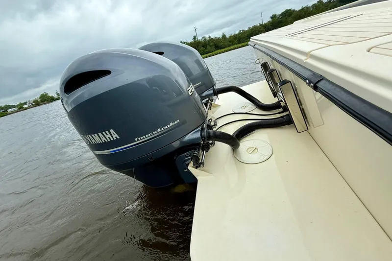 Slide: The Image of Twin Yamaha outboard engines on a 2008 Parker 2520XLD boat, docked on a cloudy day. - 8
